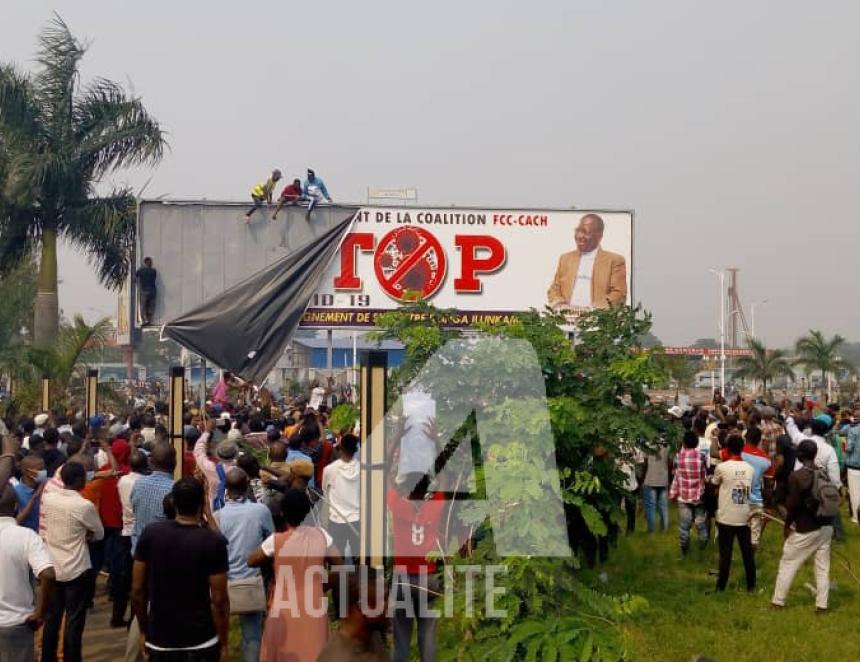 Les militants de l'UDPS devant le panneau portant effigie du premier ministre au palais du peuple. Photo ACTUALITE.CD.