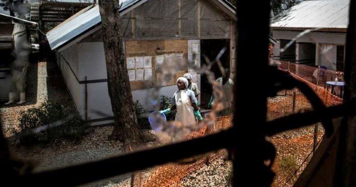 Du personnel médical vu à travers une vitre d'un centre de traitement d'Ebola / Droits tiers 