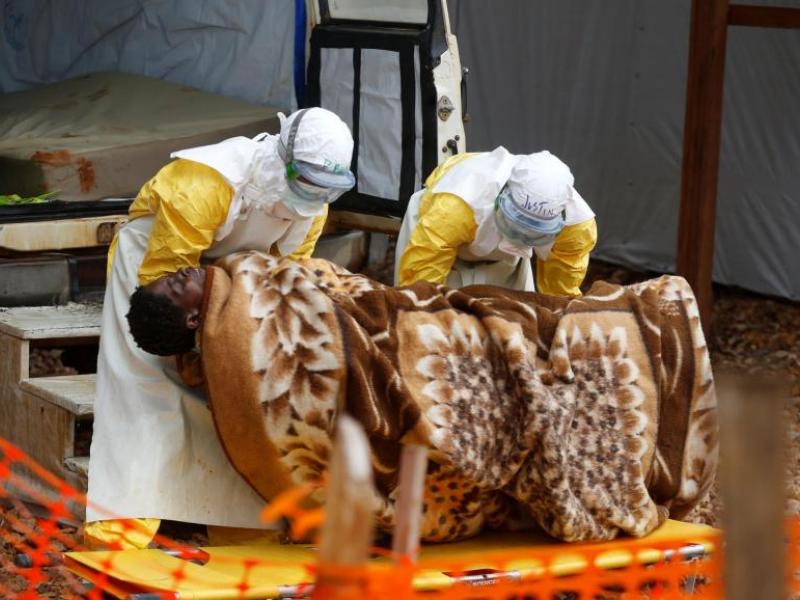 Des employés du centre Ebola de Butembo prennent en charge une femme atteinte d'Ebola, le 28 mars 2019
