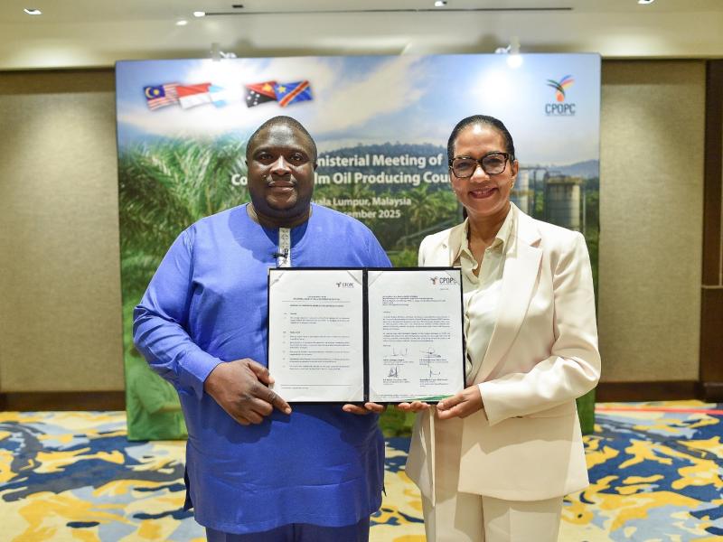 Madame Monique Gieskes, Directeur Général de PHC, et Monsieur Josué Nzangi Kambale, conseiller du ministre de l'Agriculture et de la Sécurité alimentaire de la RDC, présentent les documents officiels marquant l'adhésion de la RDC au Conseil des pays producteurs d'huile de palme lors de la 13e réunion ministérielle du CPOPC à Kuala Lumpur, en Malaisie.